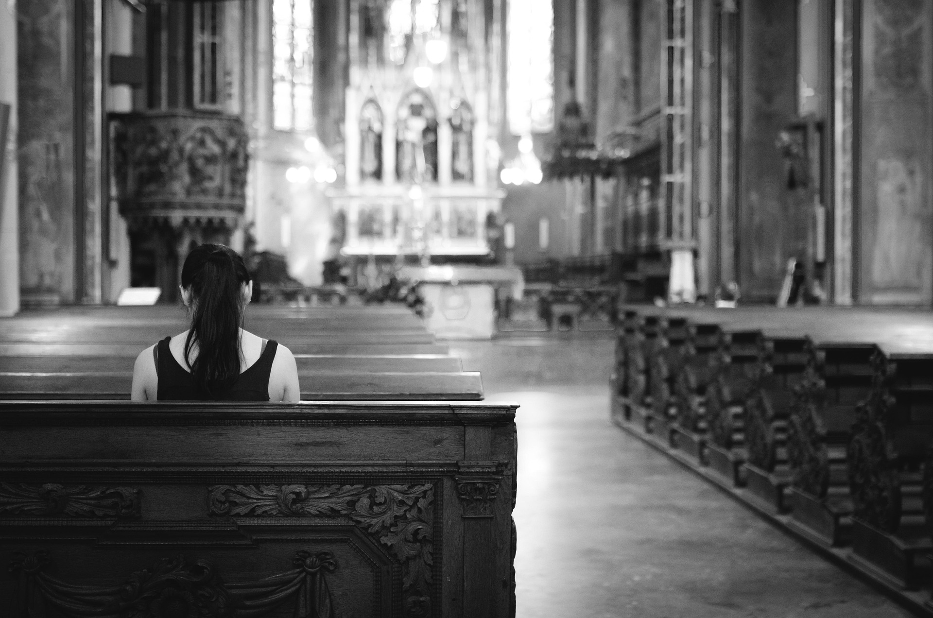 A woman sitting in a church pew